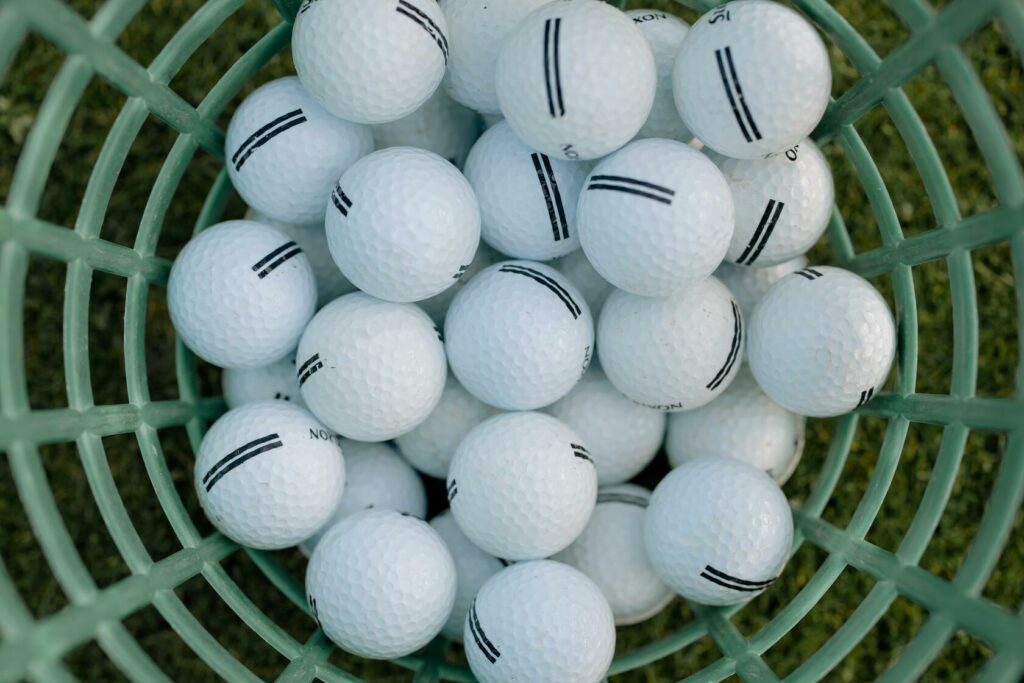 A bucket full of practice balls for beginners. Golf for Beginners