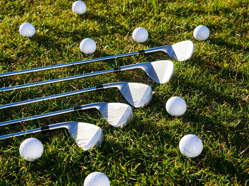 Golf Clubs on grass image