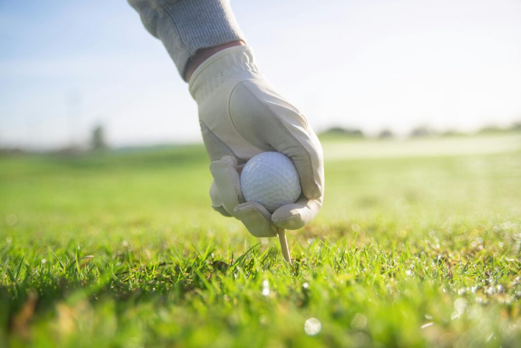 Golf Tee Sizes for Beginners. tee and golf ball image